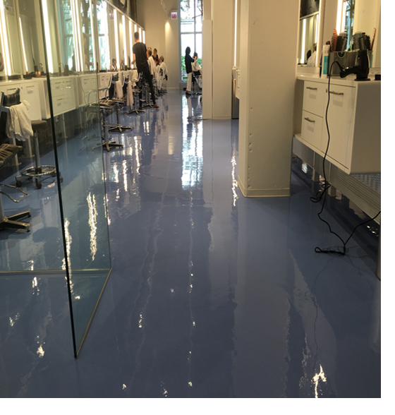 Glossy blue metallic epoxy floor in a hair salon